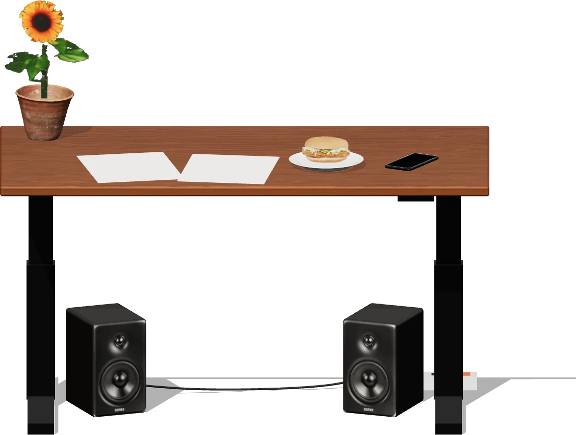 a desk with papers, a potted sunflower, a spicy chicken sandwich and a phone on it, and two speakers underneath